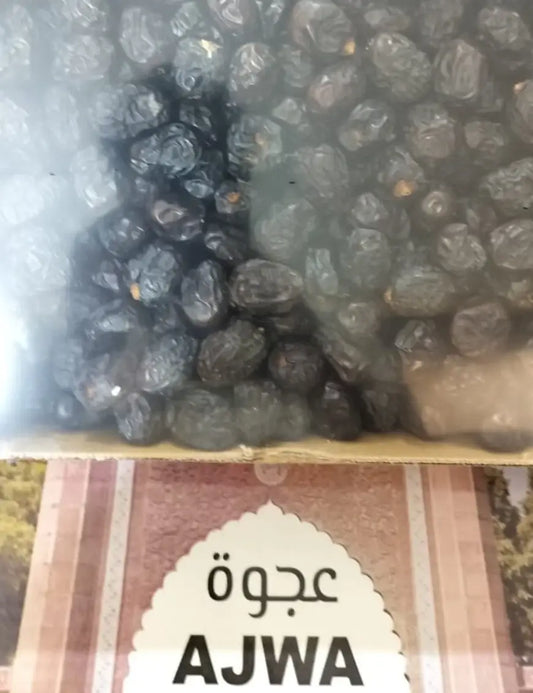 Dried fruits in a transparent container with 'AJWA' label